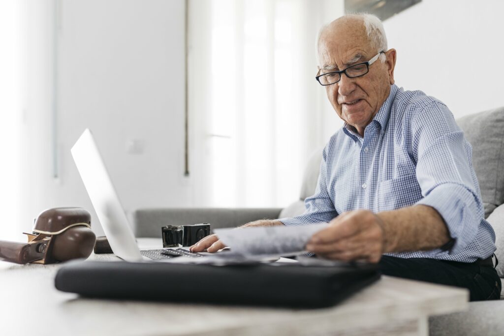 Senior man working at laptop computer at his encore career